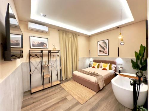 a bedroom with a bed and a tub and a sink at Falco Deluxe Home - Naples Airport & Town in Naples