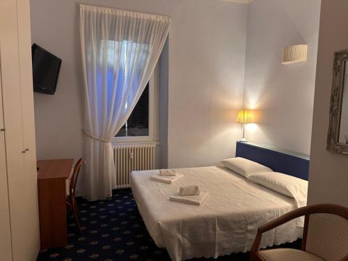 a hotel room with a bed and a window at My Hotel Milano in Milan