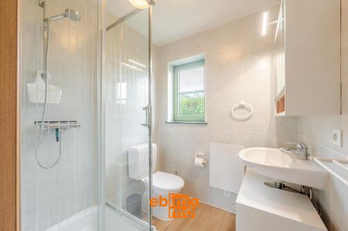 a bathroom with a shower and a sink at Nieuwendamme 69 with pool and parking in Nieuwpoort