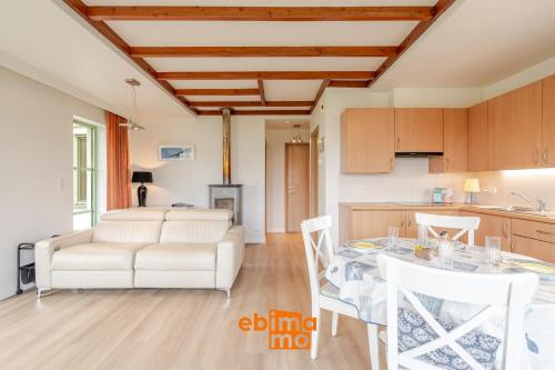 a kitchen and a living room with a table and chairs at Nieuwendamme 69 with pool and parking in Nieuwpoort