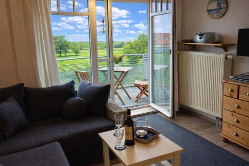 a living room with a couch and a table at de Spree in Dorum-Neufeld