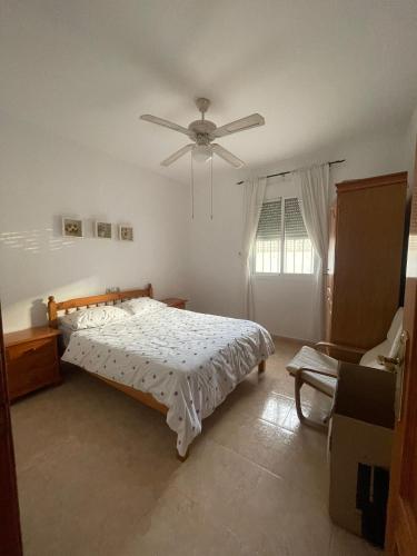 a bedroom with a bed and a ceiling fan at Villa Sparrow, Arboleas in El Arroyo Aceituno