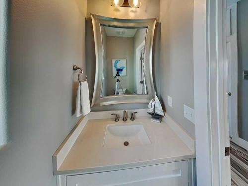 a bathroom with a sink and a mirror at All Decked Out in Padre Island