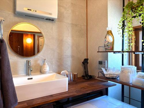 a bathroom with a sink and a mirror at Snoa Kitanomine - スノア キタノミネ - in Furano