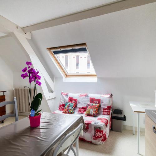 a living room with a couch and a window at Villa MERYEM in Néris-les-Bains