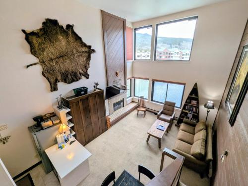 a living room with a couch and a table at Edgewater 1448 by SummitCove Lodging in Colorado in Keystone