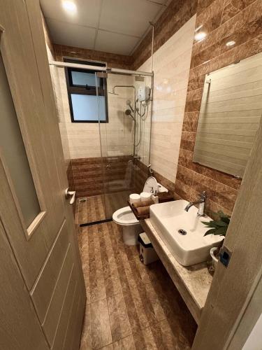 a bathroom with a toilet and a sink and a shower at Ceilé Stay Đà Lạt in Da Lat