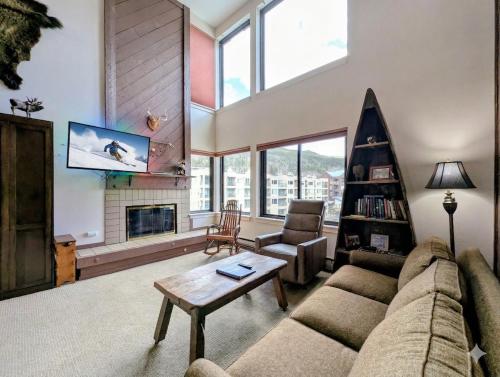 a living room with a couch and a table at Edgewater 1448 by SummitCove Lodging in Colorado in Keystone