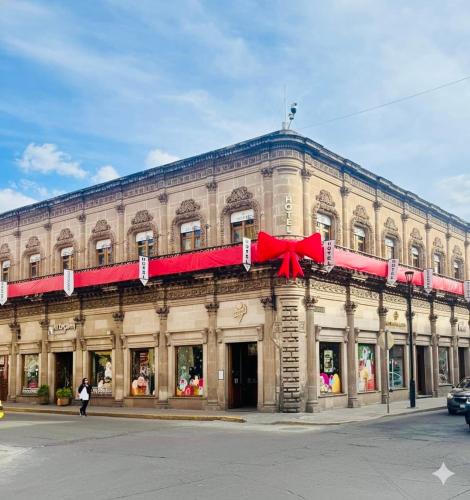 a large building with a red bow on it at Palacio de las Rosas in Durango