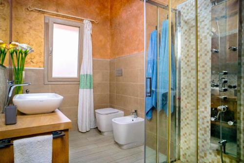 a bathroom with a toilet and a sink and a shower at Villa Chia 2 in Chia