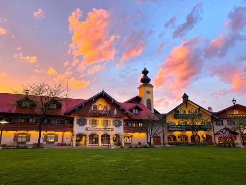 a large building with a clock tower on top of a field at Bavarian Inn Lodge in Frankenmuth