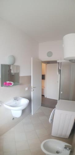 a white bathroom with a sink and a toilet at HB Appartamenti in centro Bergamo in Bergamo