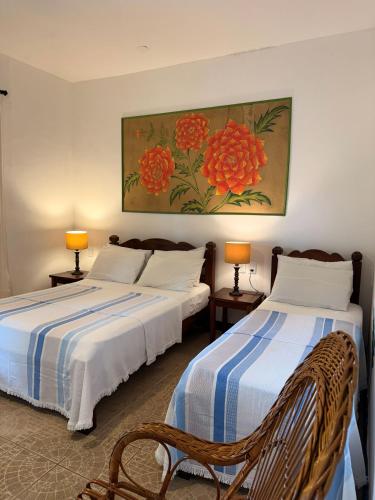 two beds sitting next to each other in a room at 4 Ventos Pousada in Paraty