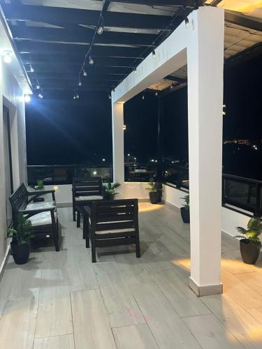 a patio with benches and a view of the city at RUKA Hotel in Punta Cana
