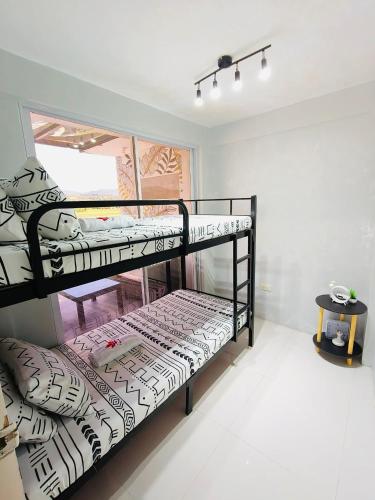 a bedroom with two bunk beds in a room at Casipe Transient House in Tanay