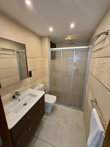 a bathroom with a shower and a sink and a toilet at Pensió Anna in Tossa de Mar