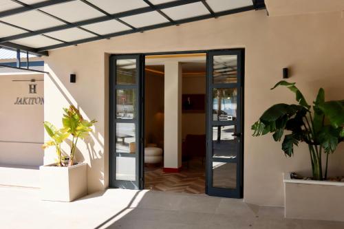 an open door of a building with potted plants at Hostal Jakiton in Palmanova