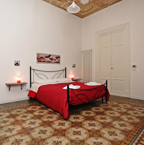 a bedroom with a large bed with a red blanket at Rest and Go in Palermo