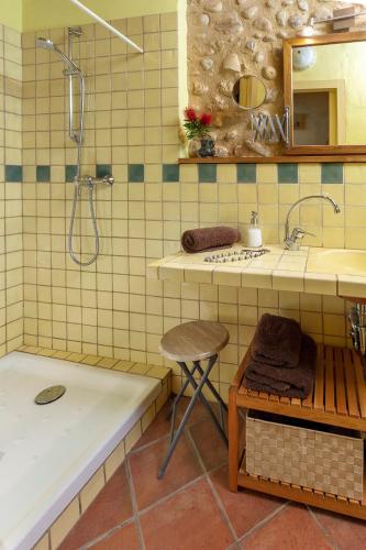 a bathroom with a tub and a sink and a shower at Can Marisch Les Arcades in Ventalló