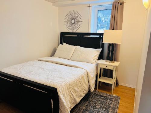 a bedroom with a bed and a table with a lamp at Gull lake in Winnipeg