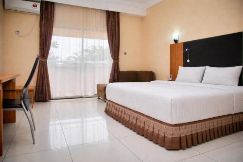 a hotel room with a large bed and a window at Royalbirds Hotel & Towers in Akure