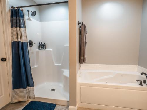 a bathroom with a white tub and a shower at Haven Hill House - Scenic Getaway near Bardstown & Bourbon Trail in Springfield