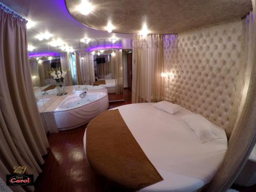 a bathroom with a bed and a tub and a sink at Carol Hotel in Piraeus