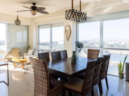 a dining room with a table and chairs at On the Malecón with ocean lagoon & pool in Mazatlán
