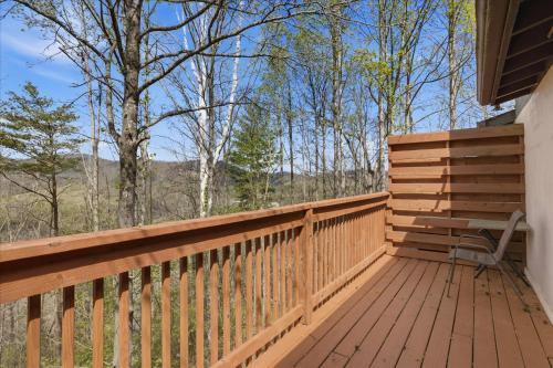 a wooden deck with a bench on it at Working 9 to Pine by Beyond Expectations with Views in Sevierville