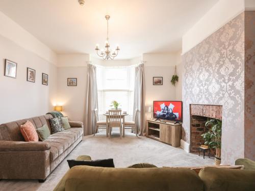 a living room with a couch and a fireplace at Bootham Apartment 32 - Free Parking - Five minute walk to York Minster in York
