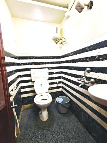 a bathroom with a toilet and a sink at Hotel O Royal in kolkata