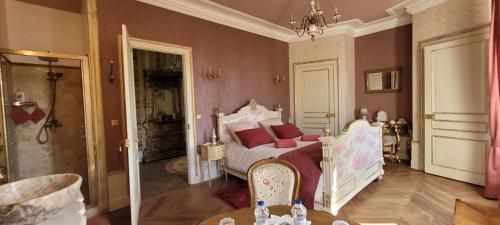 a bedroom with a white bed with red pillows at Château St Sulpice Chambre Porcelaine in Condal