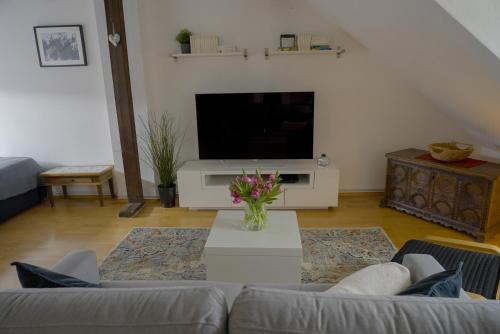 a living room with a couch and a tv at Dachgeschosswohnung in Hannover