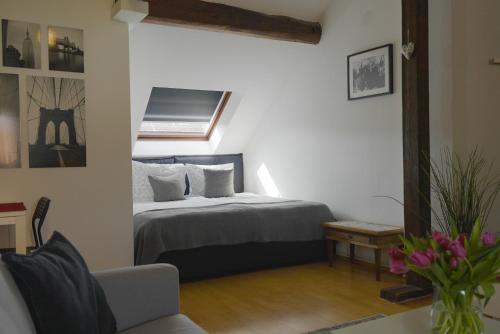 a bedroom with a bed in a room with a window at Dachgeschosswohnung in Hannover