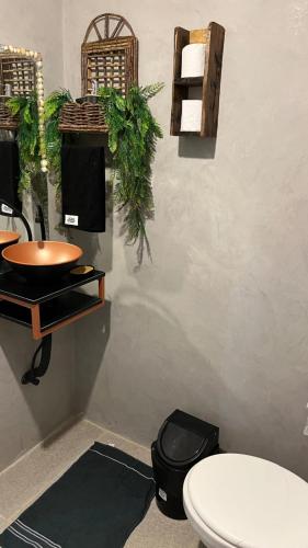 a bathroom with a toilet and a sink at Aloha Guest House in Fortaleza
