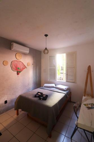 a bedroom with a bed and a window at Aloha Guest House in Fortaleza