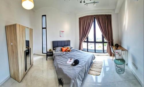 a bedroom with a bed and a large window at Metropol Holiday Suite in Bukit Mertajam