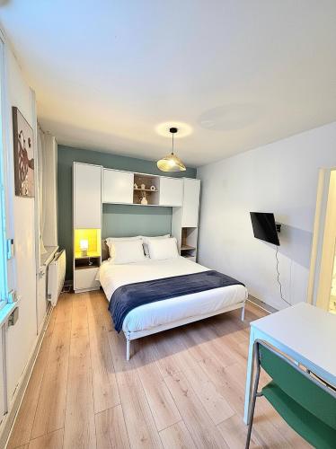 a bedroom with a bed and a television in it at A l'orée de Croix - AbsoluteHome in Croix
