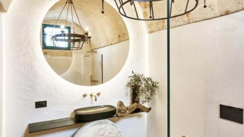 a bathroom with a mirror and a sink at Bambarone L'Agriturismo in Fasano