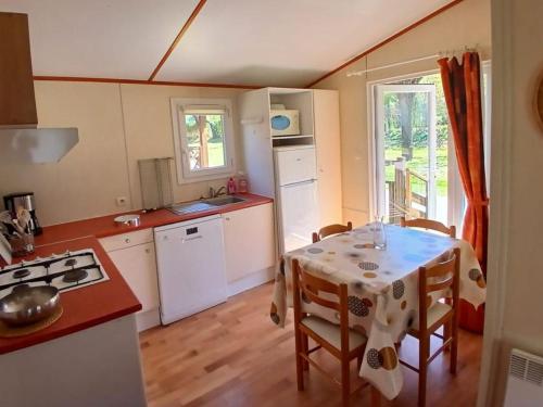a kitchen with a table with a table cloth at Chalet confortable avec terrasse - 6 pers. - API-1-52-2004 in Saint-Oyen