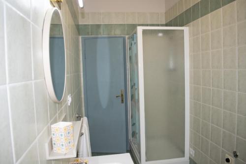 a bathroom with a shower and a sink and a mirror at La casetta di Leo in Poggibonsi