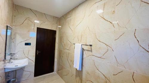 a bathroom with a sink and a toilet and a mirror at Seaside Residence Negombo in Negombo