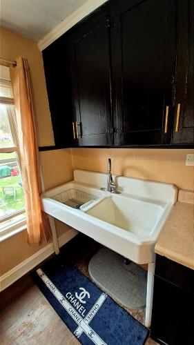 a white sink in a kitchen with a window at Humble beginning 605 EM in Norwich