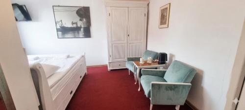 a room with a bed and two chairs and a table at Villa Zosieńka - FREE PARKING - Blisko Forum & Stare Miasto in Gdańsk