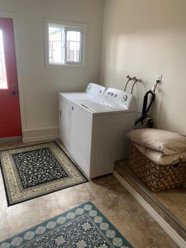 a washer and dryer in a room with a door at Spry Church Cozy Cottage in Lion's Head