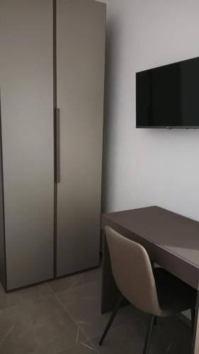 a room with a desk and a chair and a television at Apartment for 4 in Cairo Montenotte