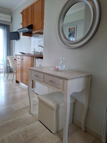 a kitchen with a table with a mirror on the wall at Apartments Chania in Chania