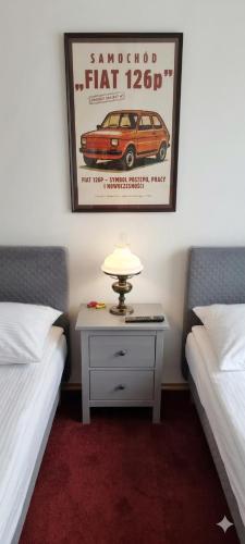 a bedroom with two beds and a table with a car on it at Villa Zosieńka - FREE PARKING - Blisko Forum & Stare Miasto in Gdańsk
