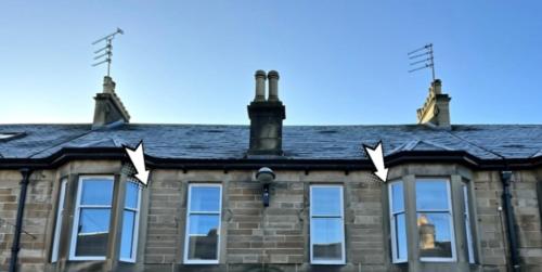 a house with windows and antennas on the roof at West Highland Apartments Milngavie - The Nevis in Milngavie