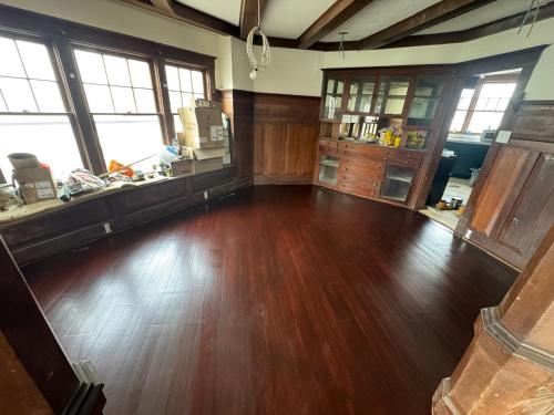 an empty room with a hard wood floor and windows at Historic 1908 Wamsley House-Completing Renovation! in Hamilton